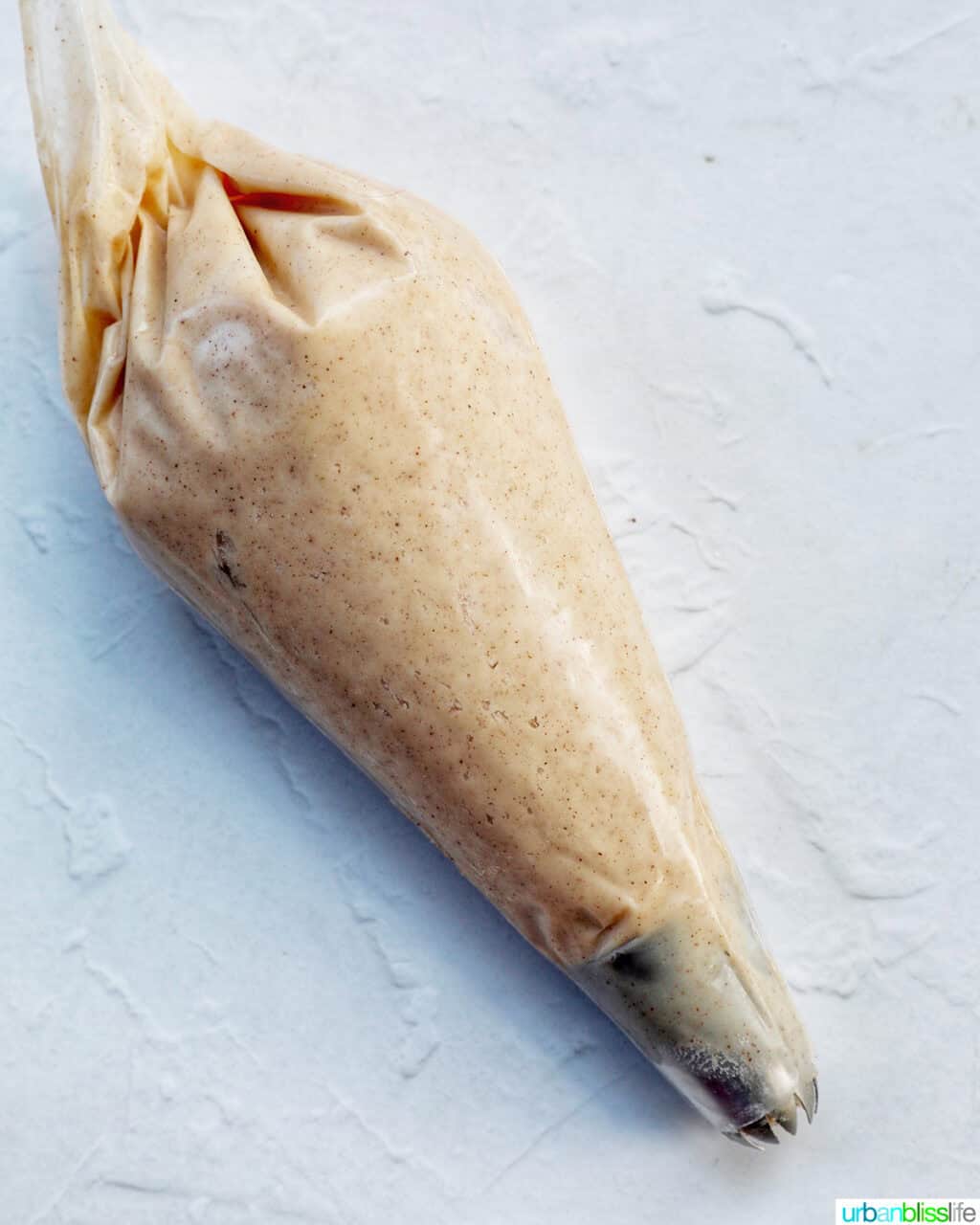 cinnamon buttercream frosting in a piping bag.