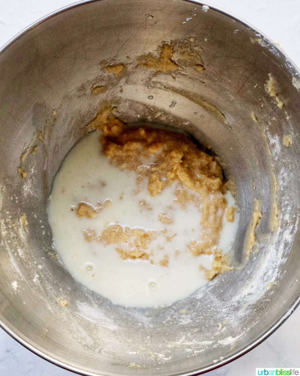 milk added to cupcake batter in a stand mixer bowl.