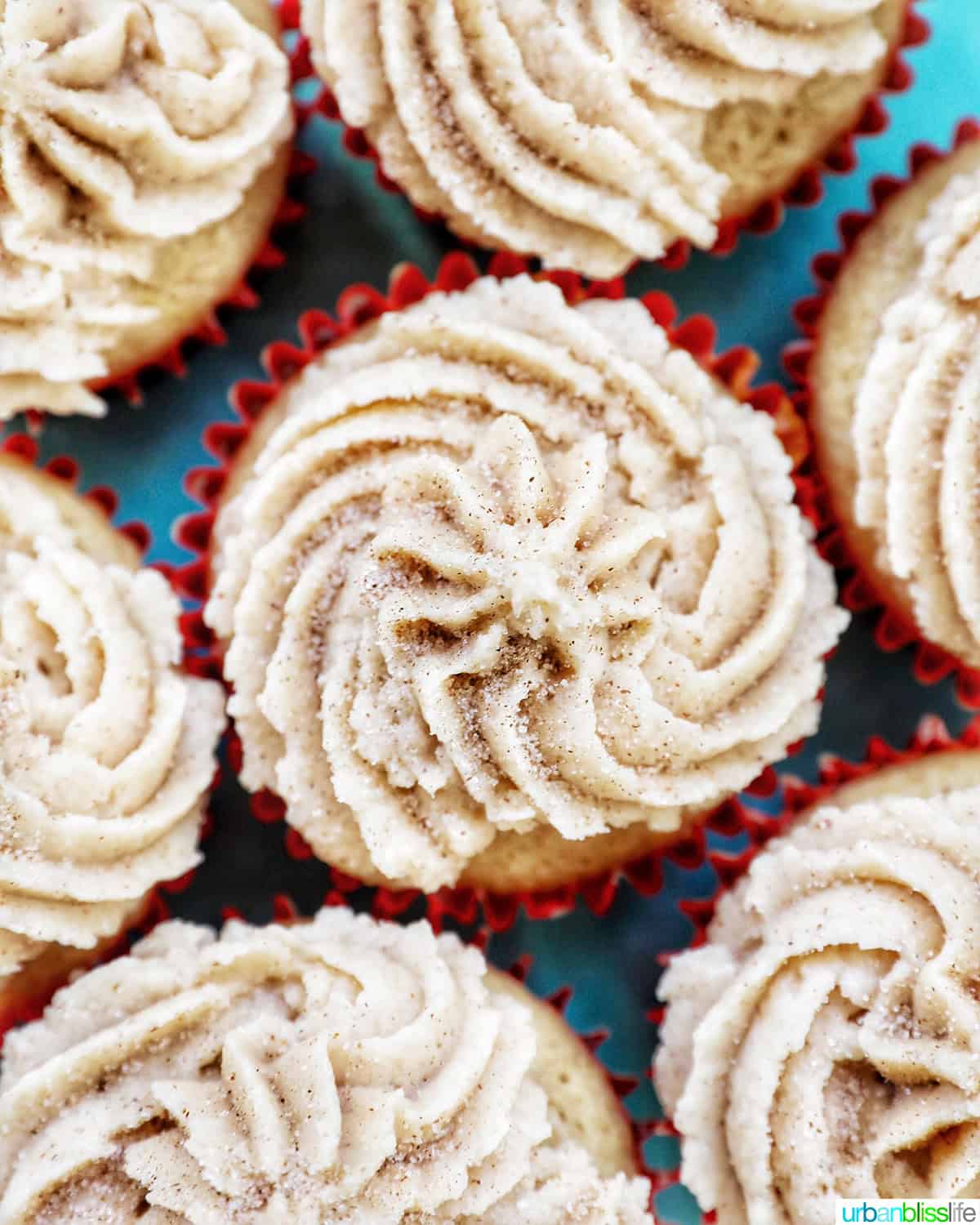 overhead closeup view of cinnamon cupcakes on a blue cake pedestal.