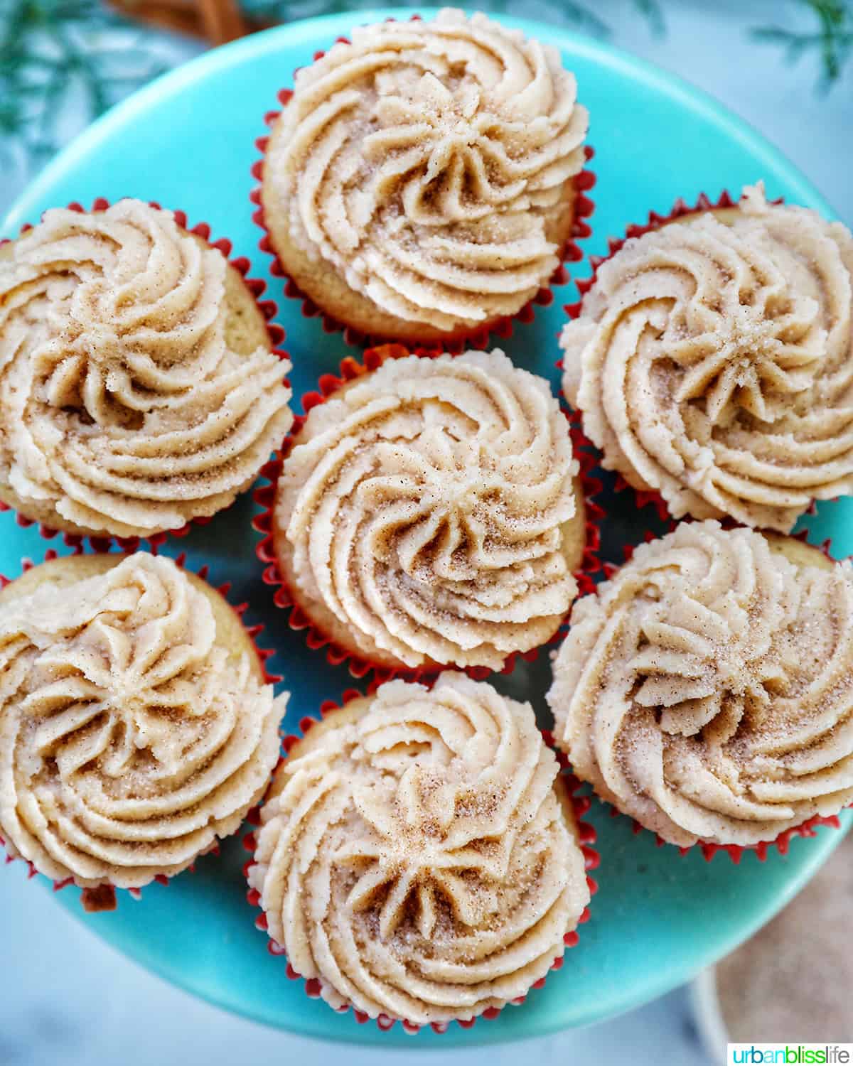 cinnamon cupcakes on a blue cake pedestal.