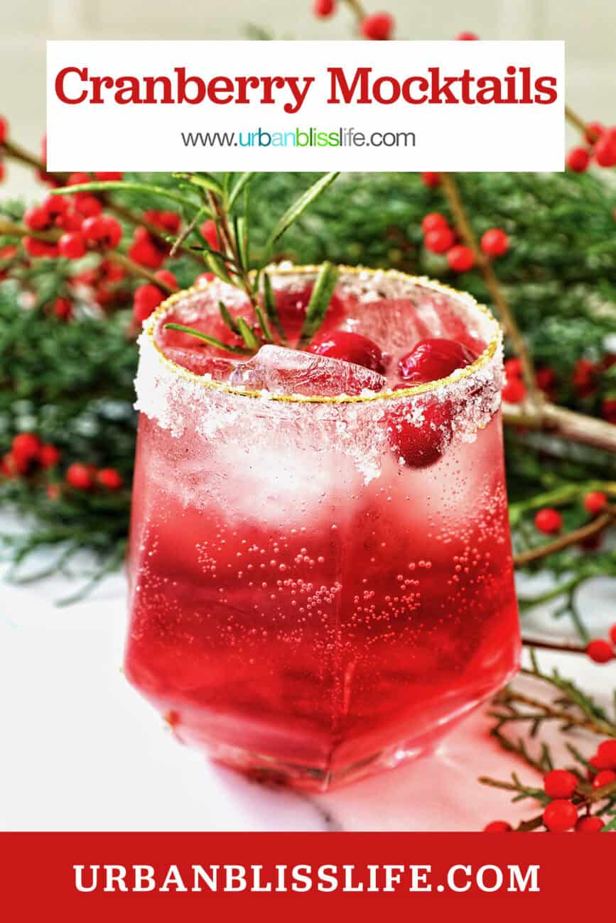 glass of cranberry mocktail drink with festive christmas decorations.
