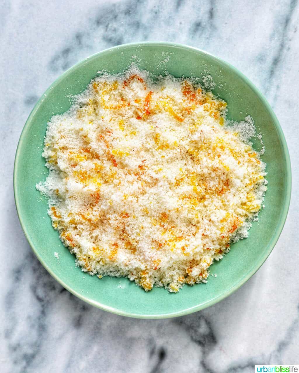 orange zest and sugar combined in a shallow bowl to make citrus sugar.
