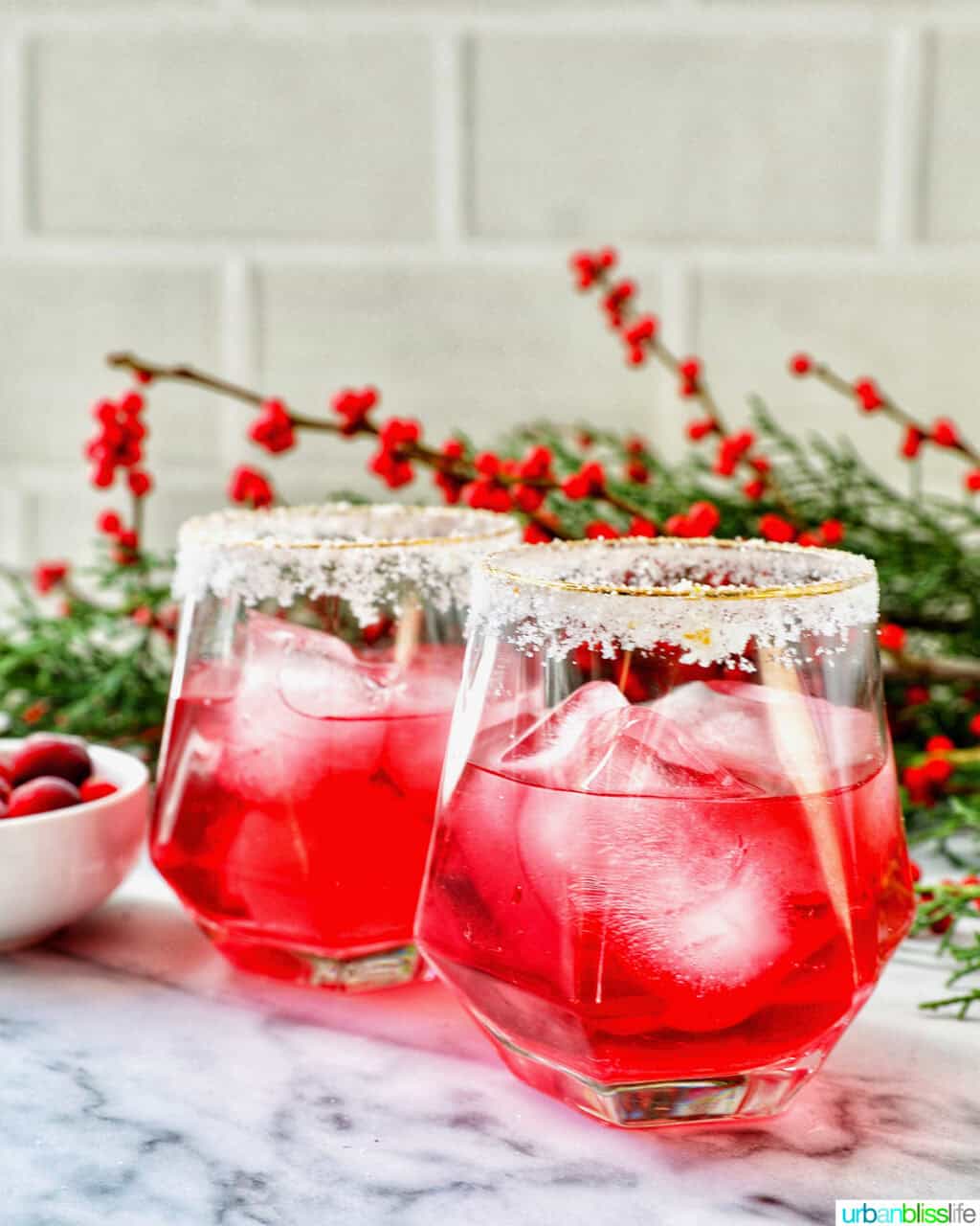 glasses of cranberry mocktail drink with festive christmas decorations.