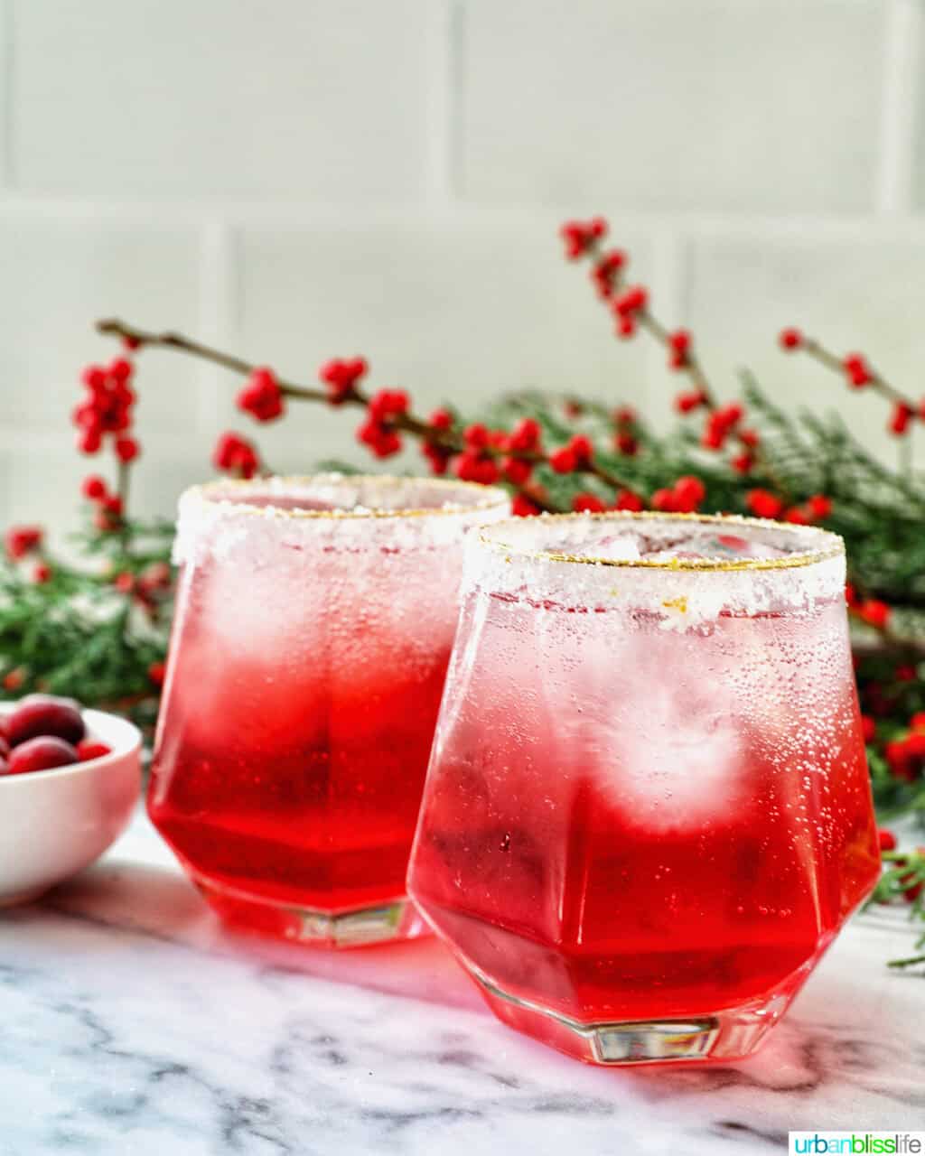 glasses of cranberry mocktail drink with festive christmas decorations.