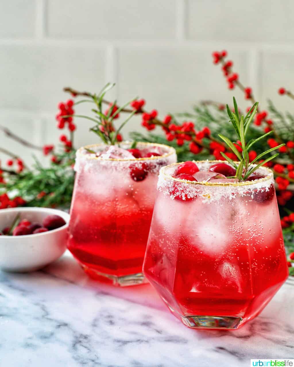 glasses of cranberry mocktail drink with festive christmas decorations.
