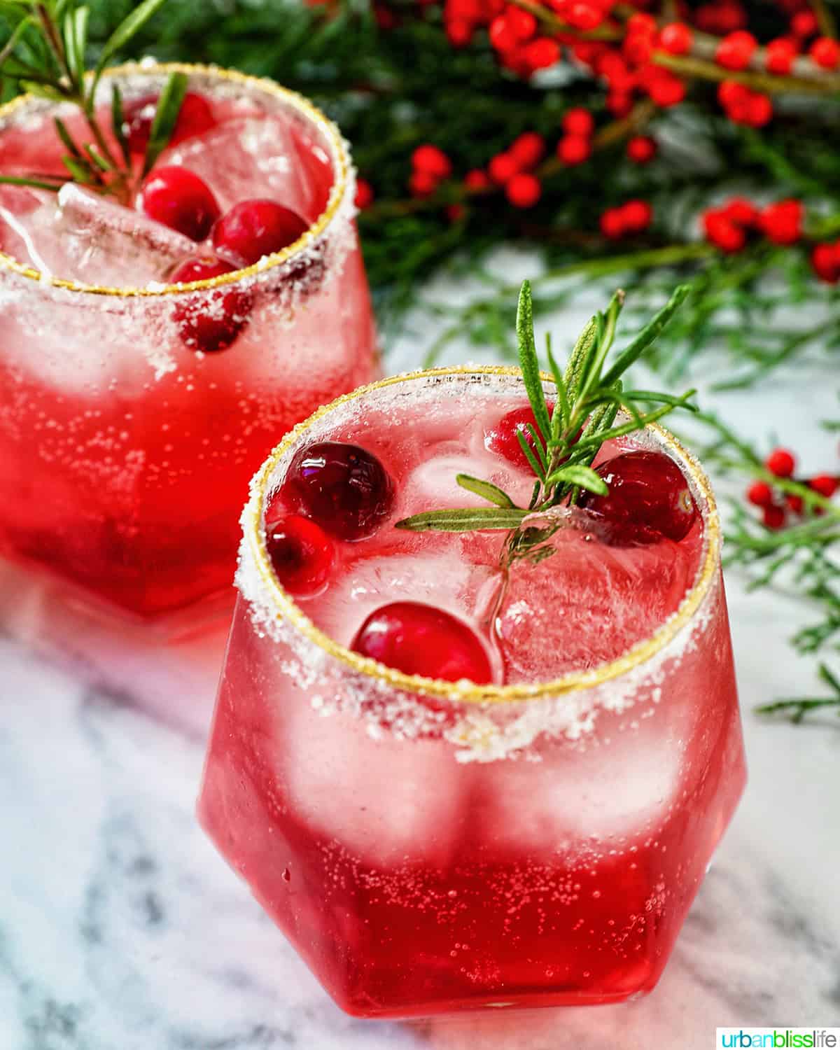 glasses of cranberry mocktail drink with festive christmas decorations.