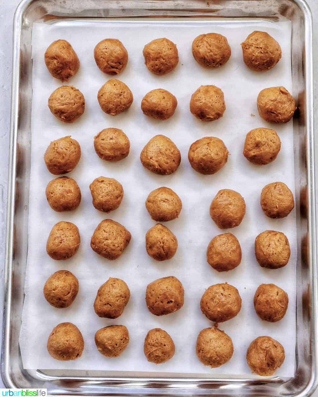 rows of gingerbread truffles on a baking sheet.