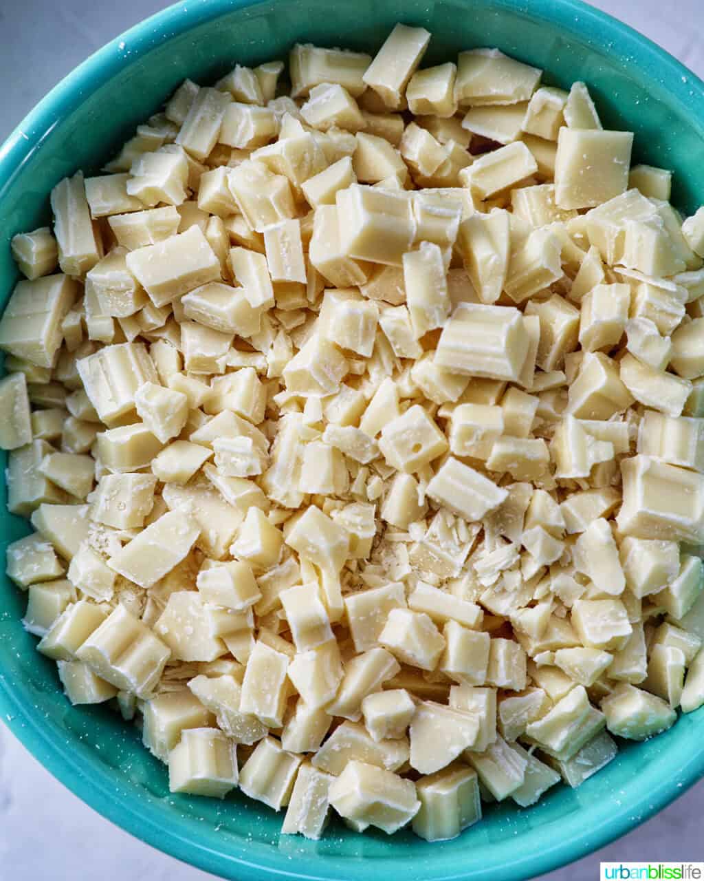chopped white chocolate in a blue bowl.
