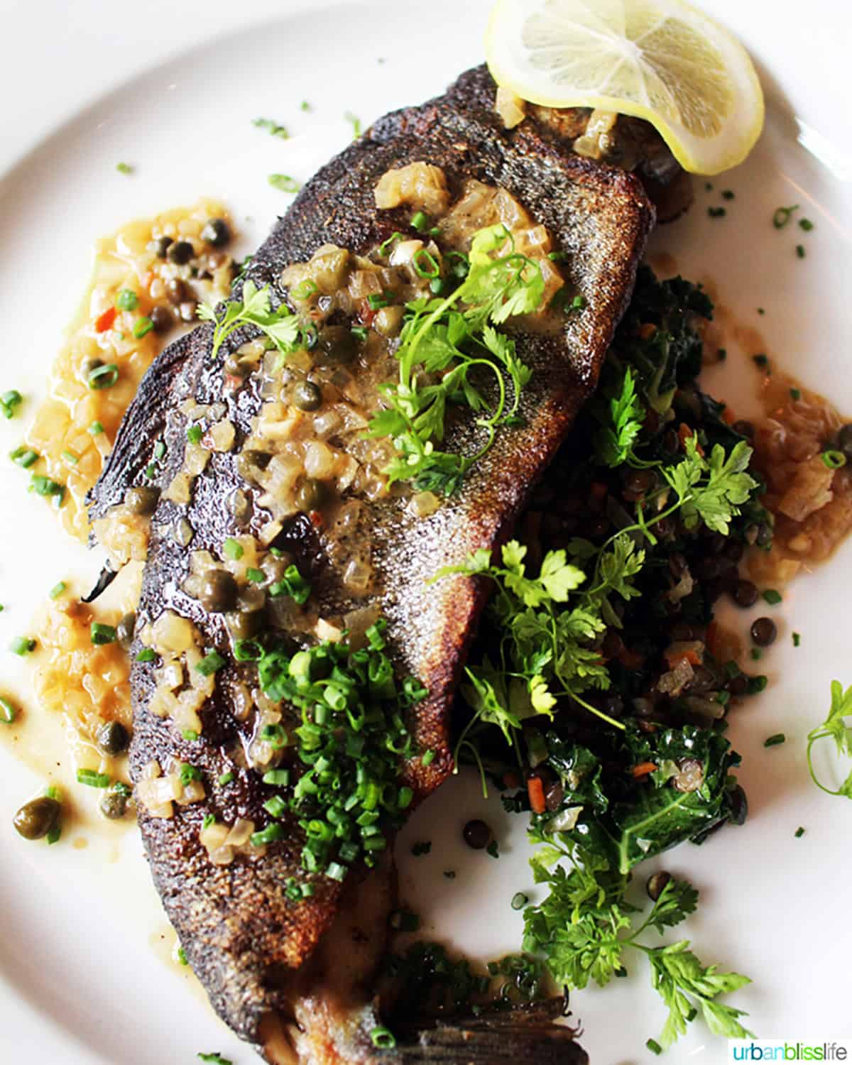 trout muniere on a white plate.