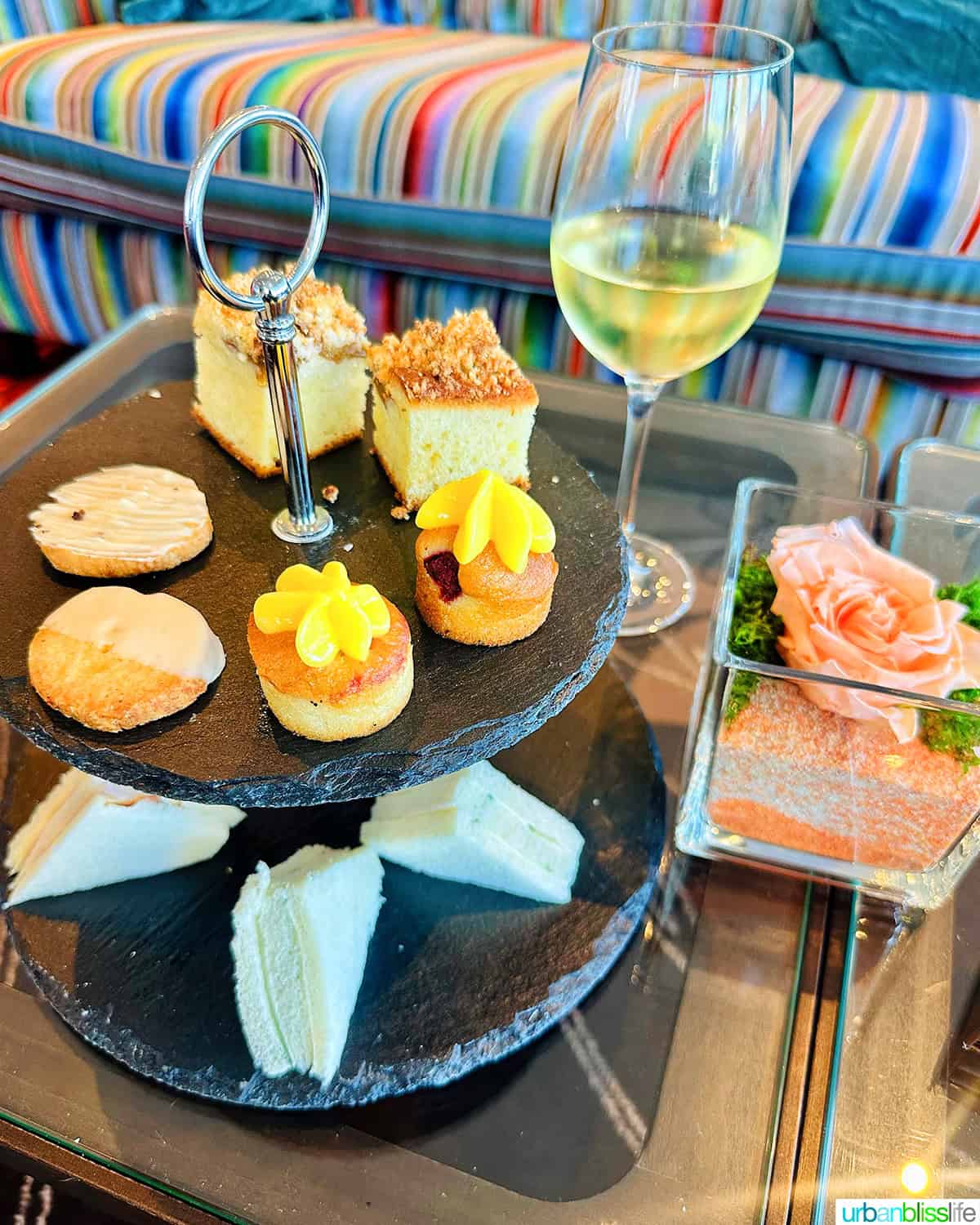 afternoon tea tray with light bites and glass of wine on AmaWaterways river cruise.