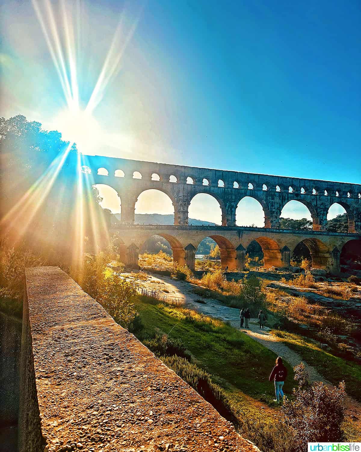 pont du gard with sun behind