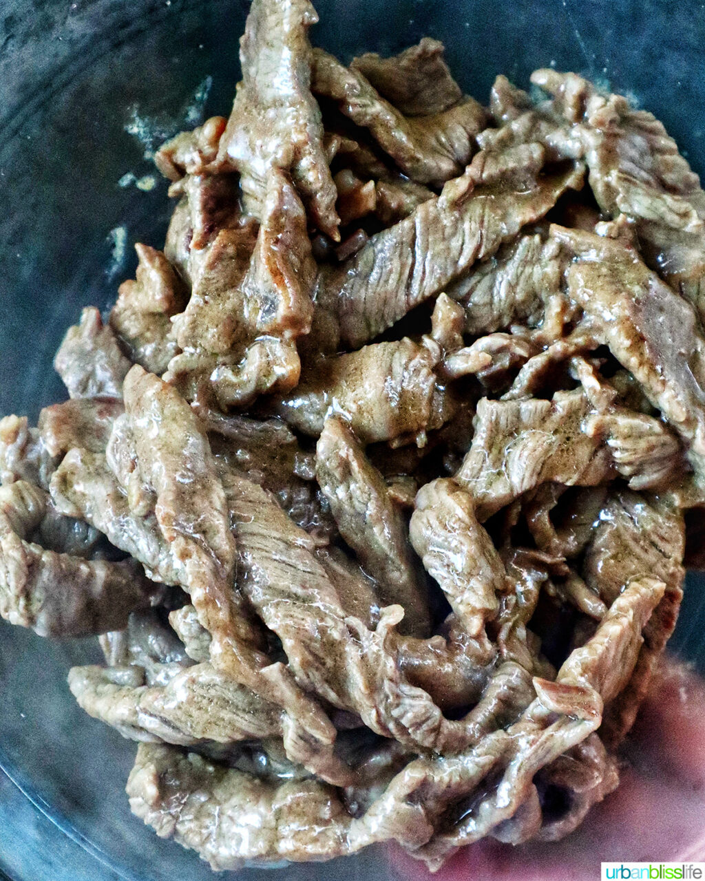 sliced beef cooking in a pan.
