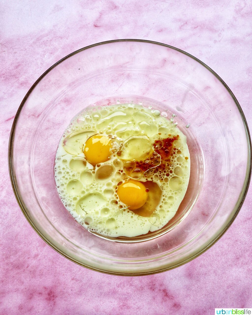 bowl with eggs and wet ingredients for muffin batter.