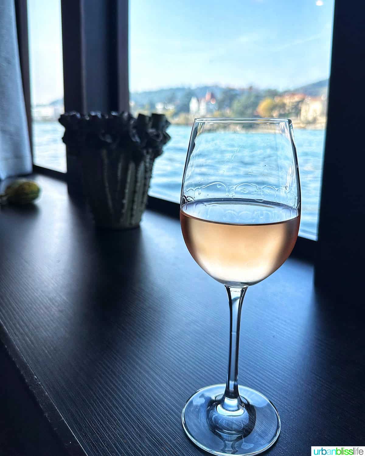 glass of rose wine by the window while sailing the Rhone River on AmaWaterways.