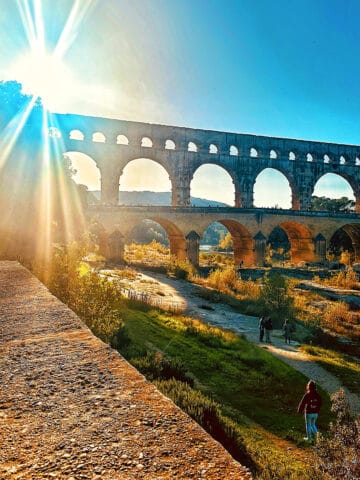 pont du gard with sunburst.