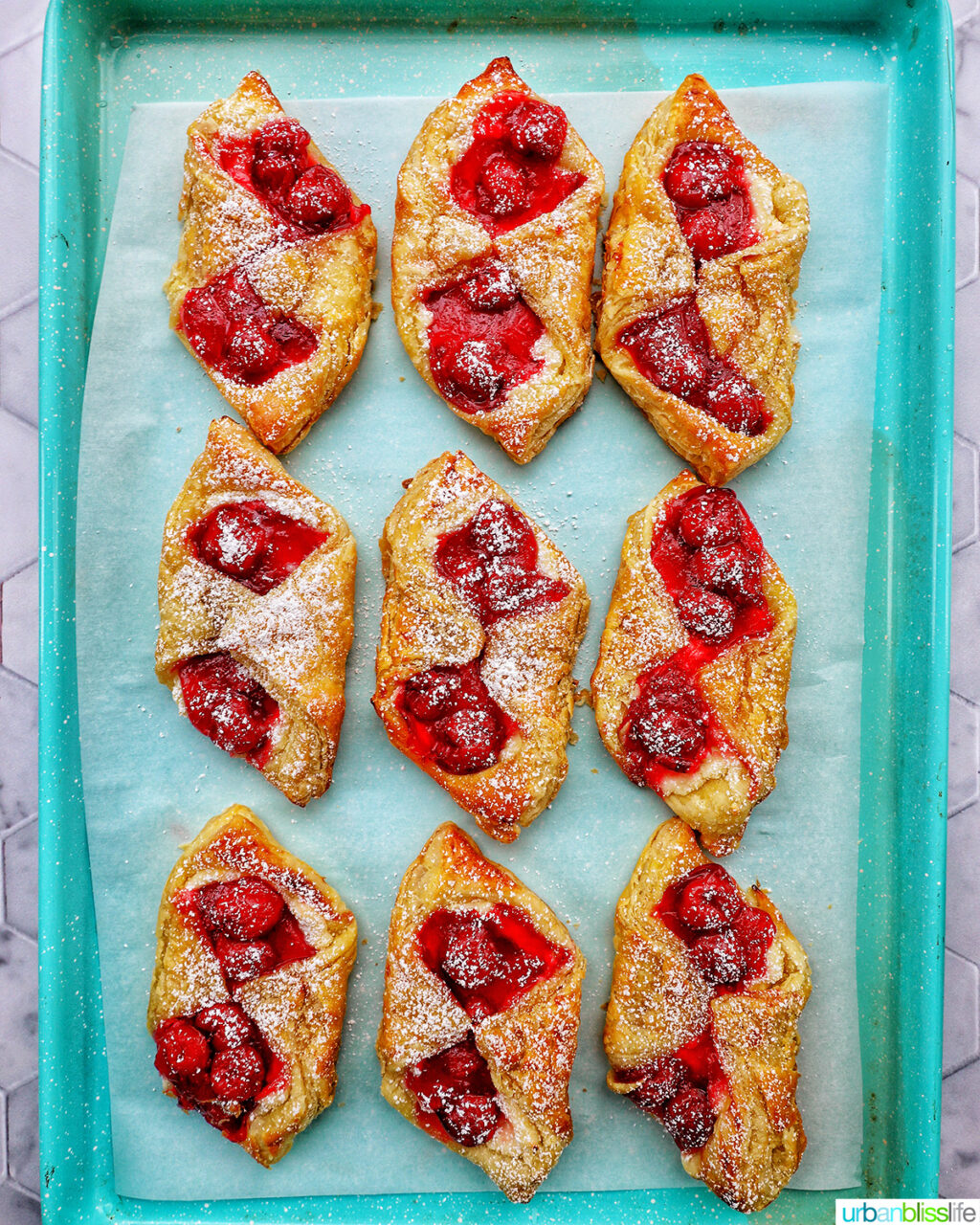 cherry danish pastries on a baking sheet.