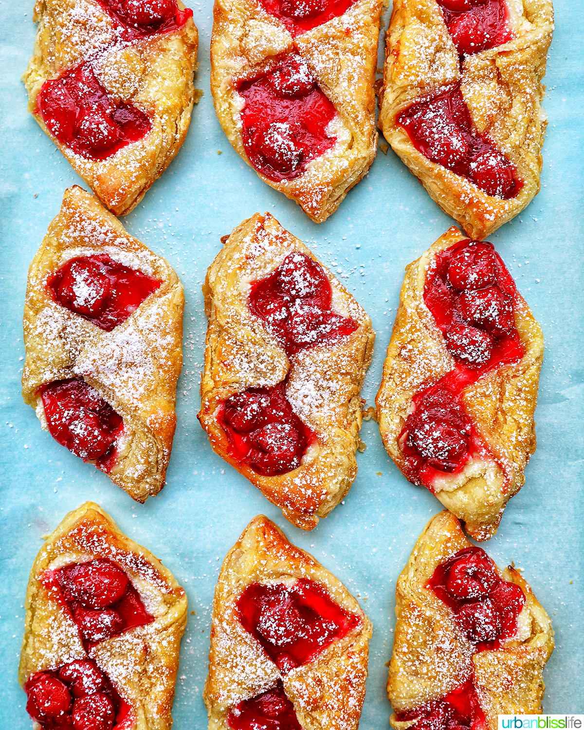 cherry danish pastries on a baking sheet.