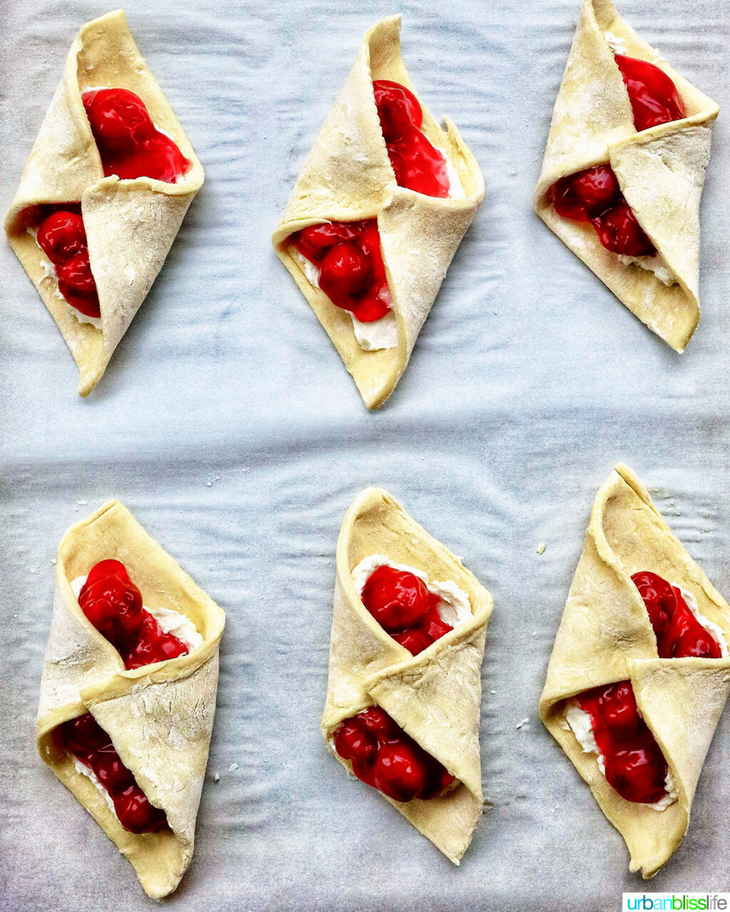 cherry danish pastries on a baking sheet.