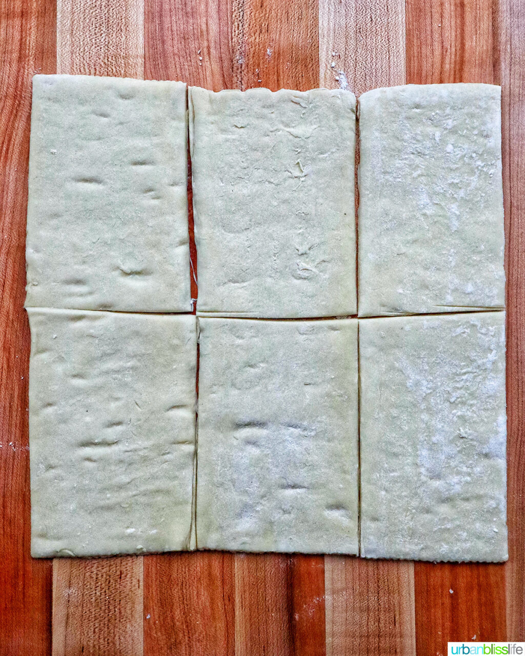 puff pastry sheets on a cutting board.