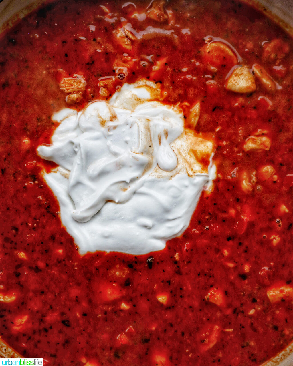 chorizo chicken pasta cooking in a pan.
