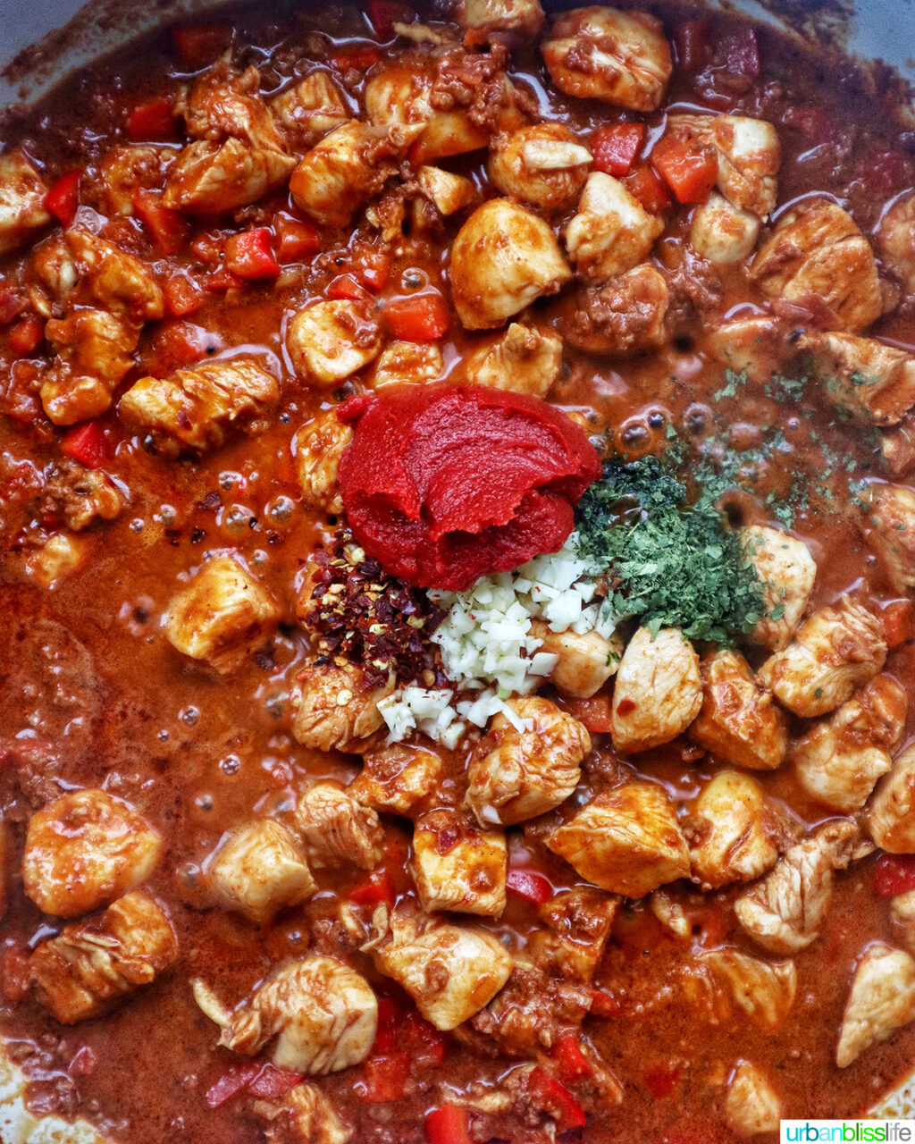 chorizo chicken pasta cooking in a pan.