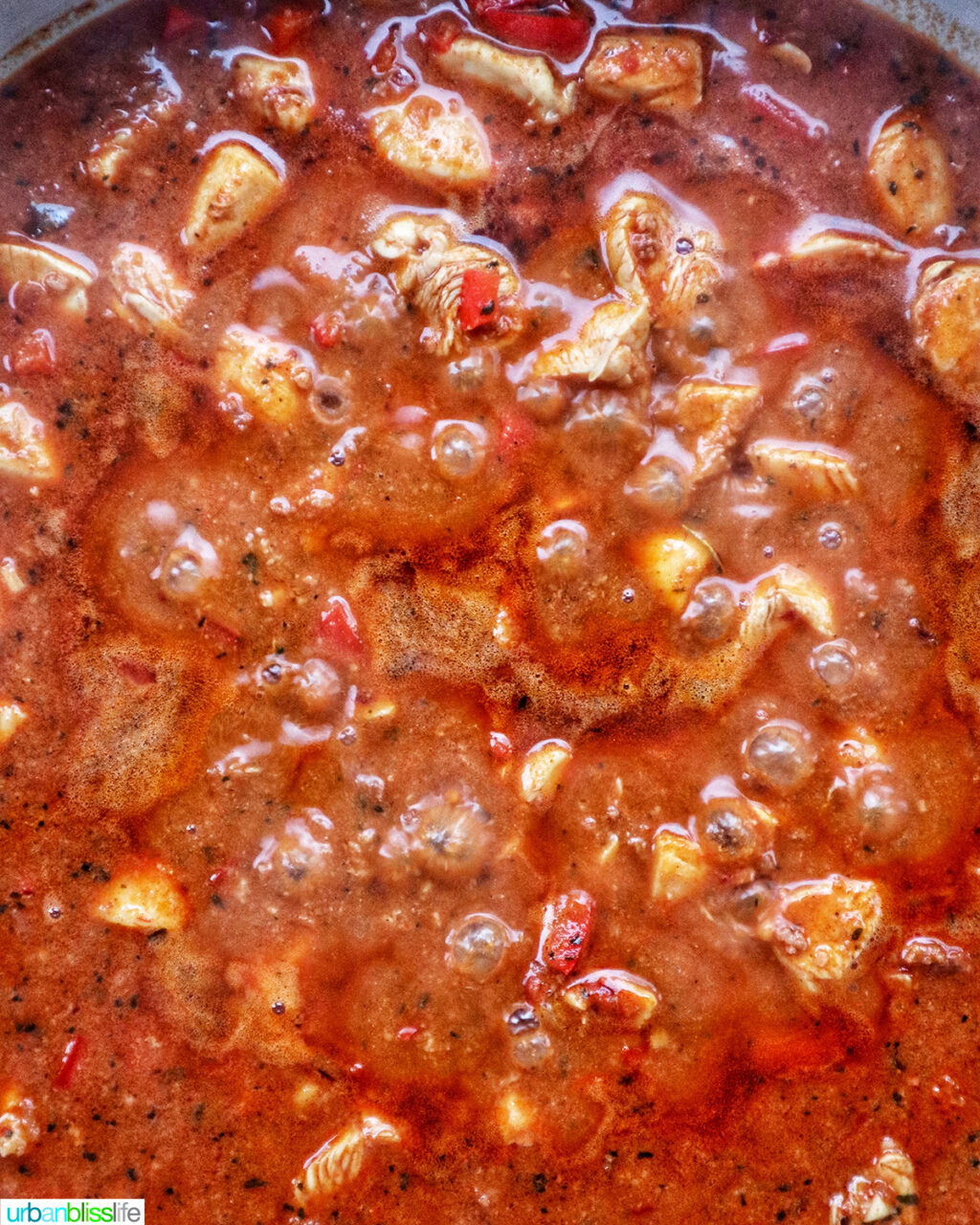 chorizo chicken pasta cooking in a pan.