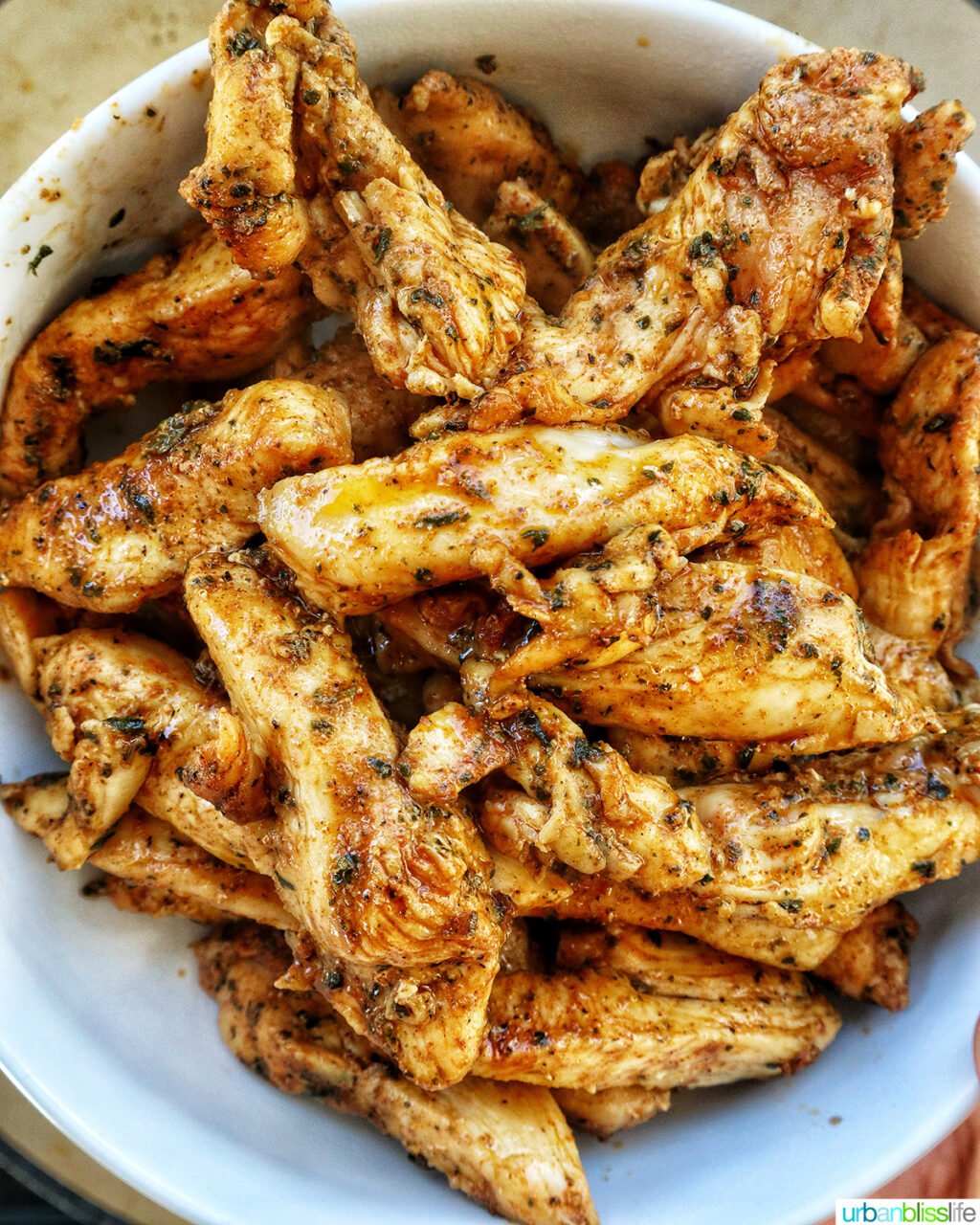 cooked sliced chicken cooking in a bowl.