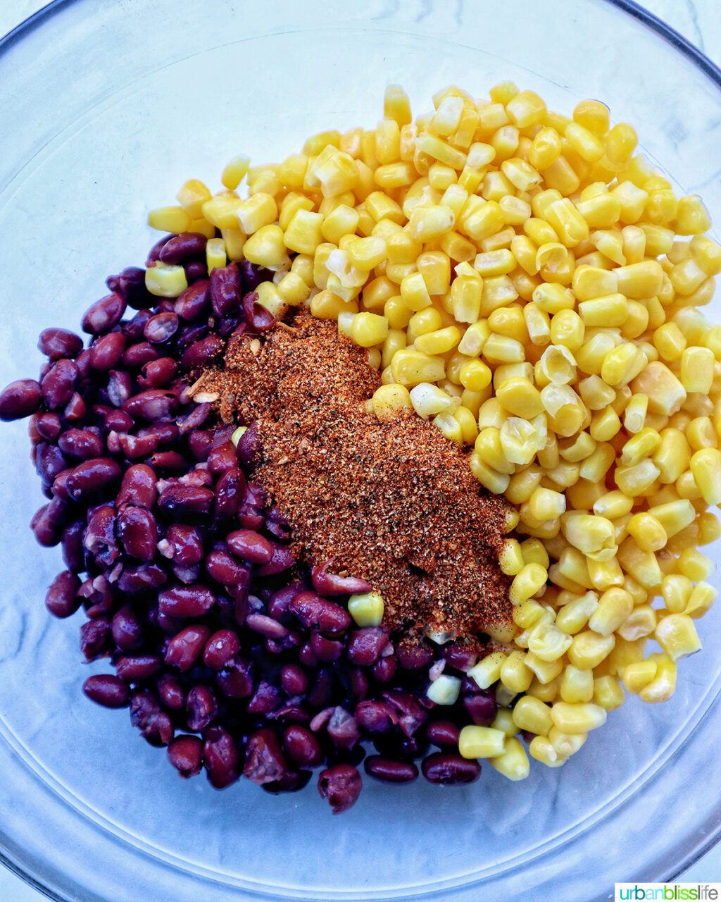corn, beans, and seasoning in a bowl.