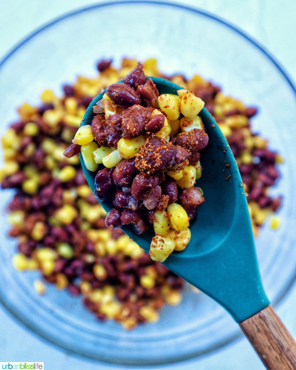 spoonful of corn, beans, and seasoning.