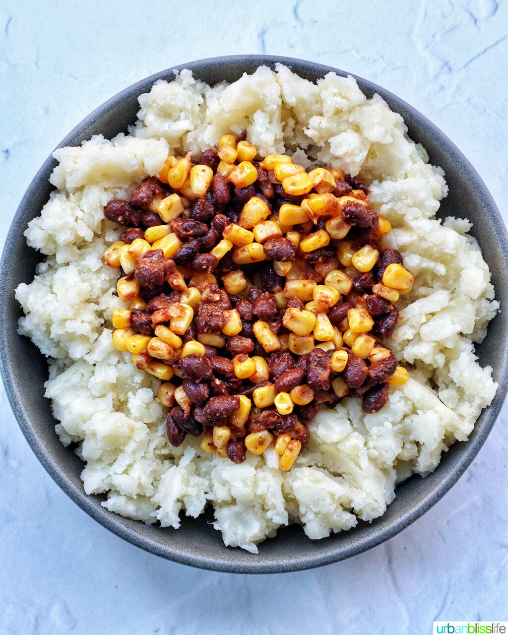 loaded potato bowl with mashed potatoes, beans, corn.