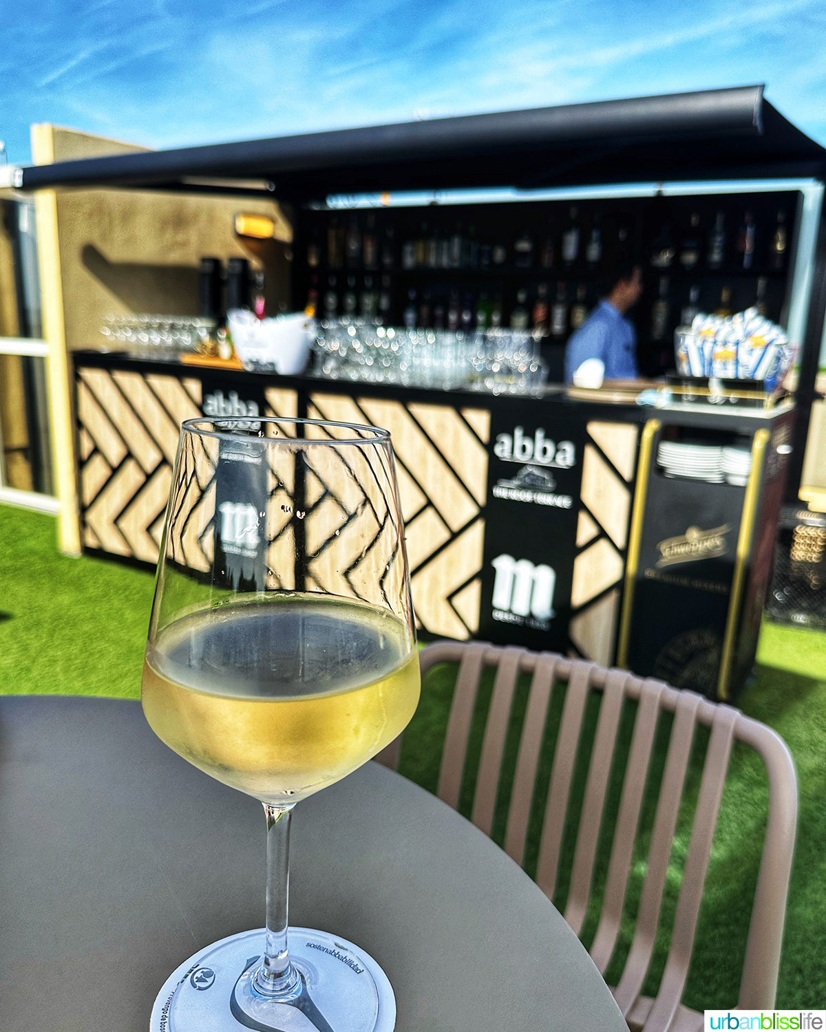 glass of txakoli wine on rooftop bar at hotel abba san sebastian