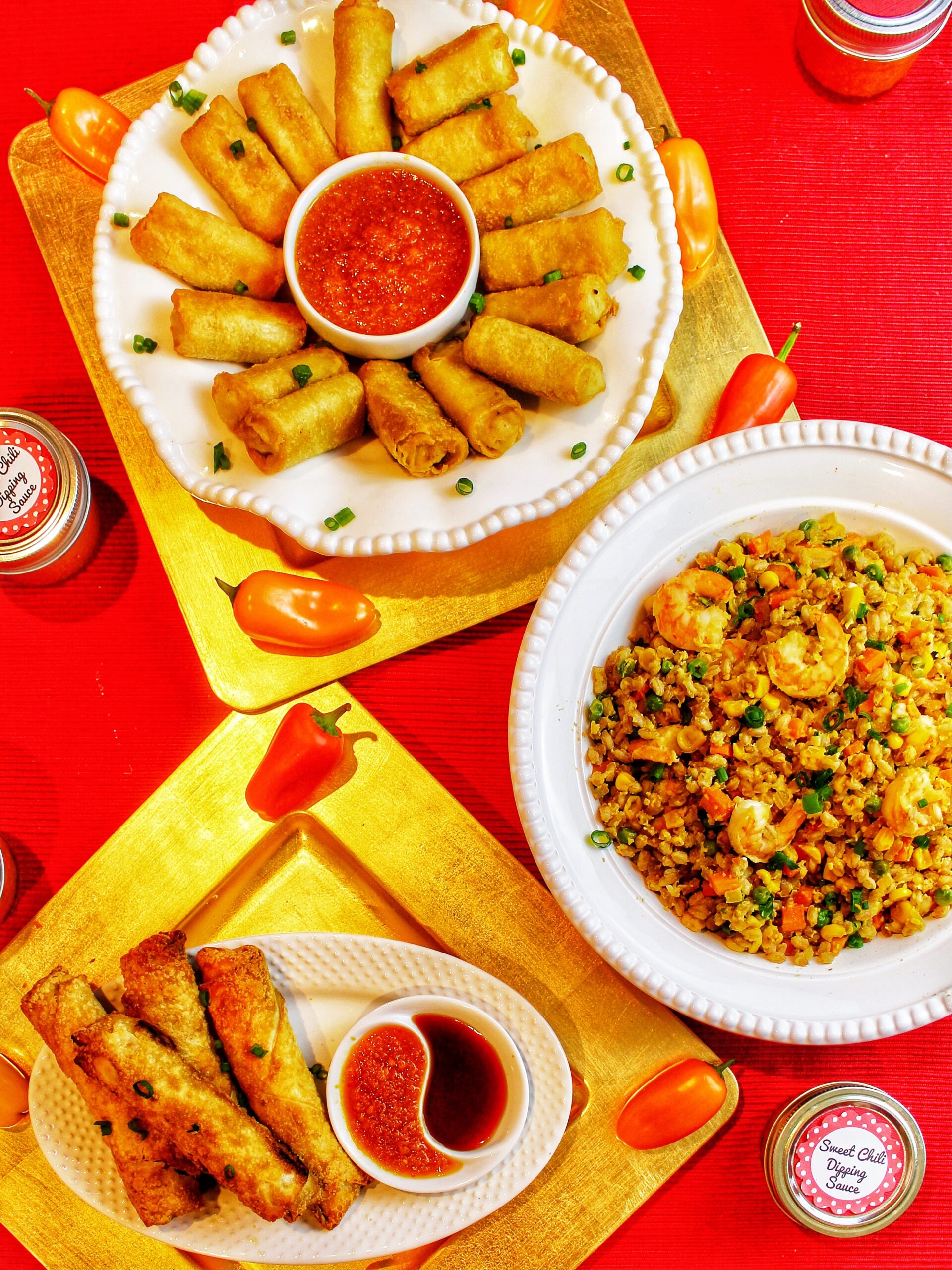 egg rolls, fried rice and dumplings on plates for Lunar New Year celebration.