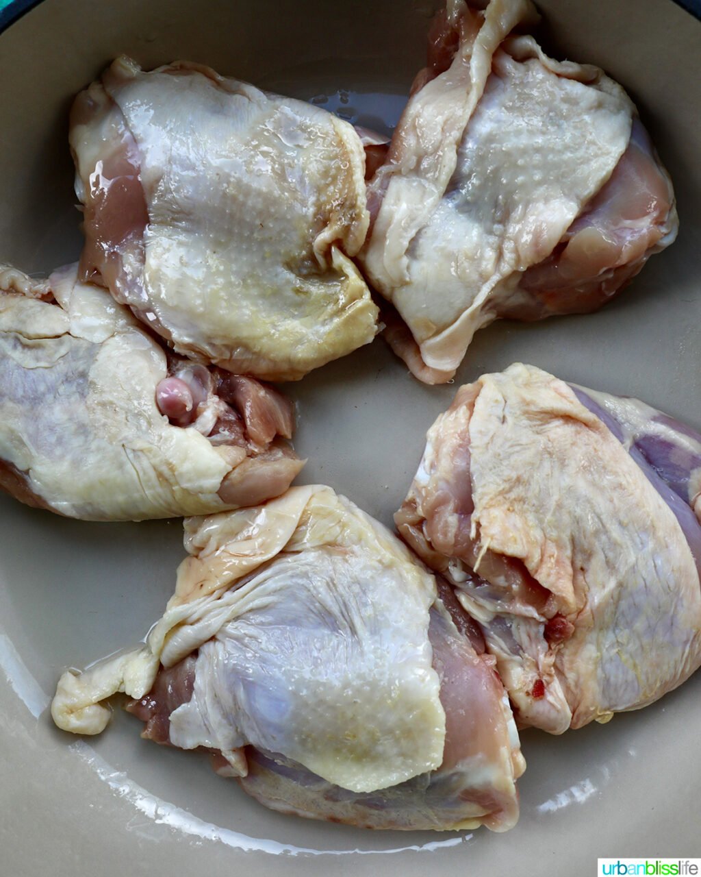chicken thighs in a skillet.