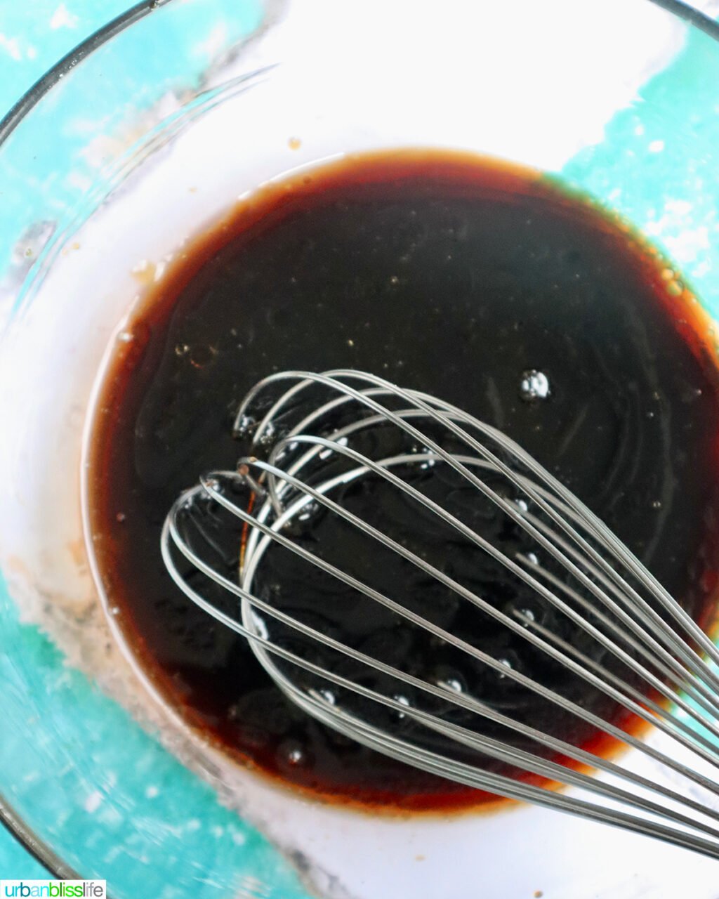 sauce in a bowl with a whisk.
