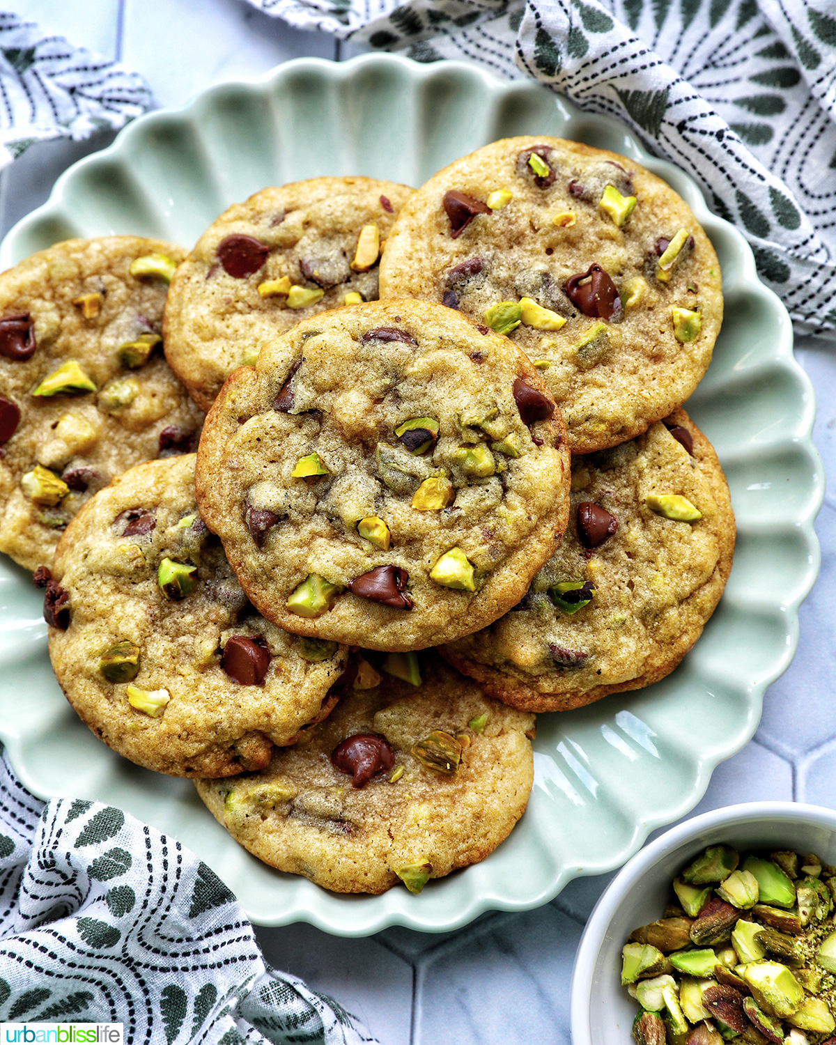 chocolate chip pistachio cookies on a plate.