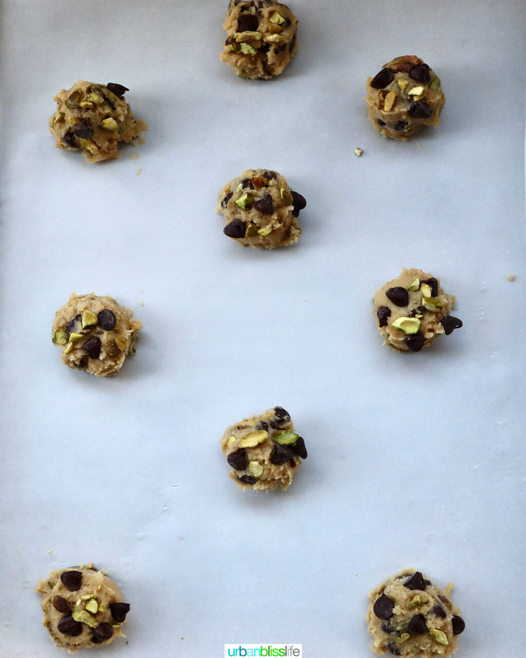 cookie batter dough balls on a baking sheet.