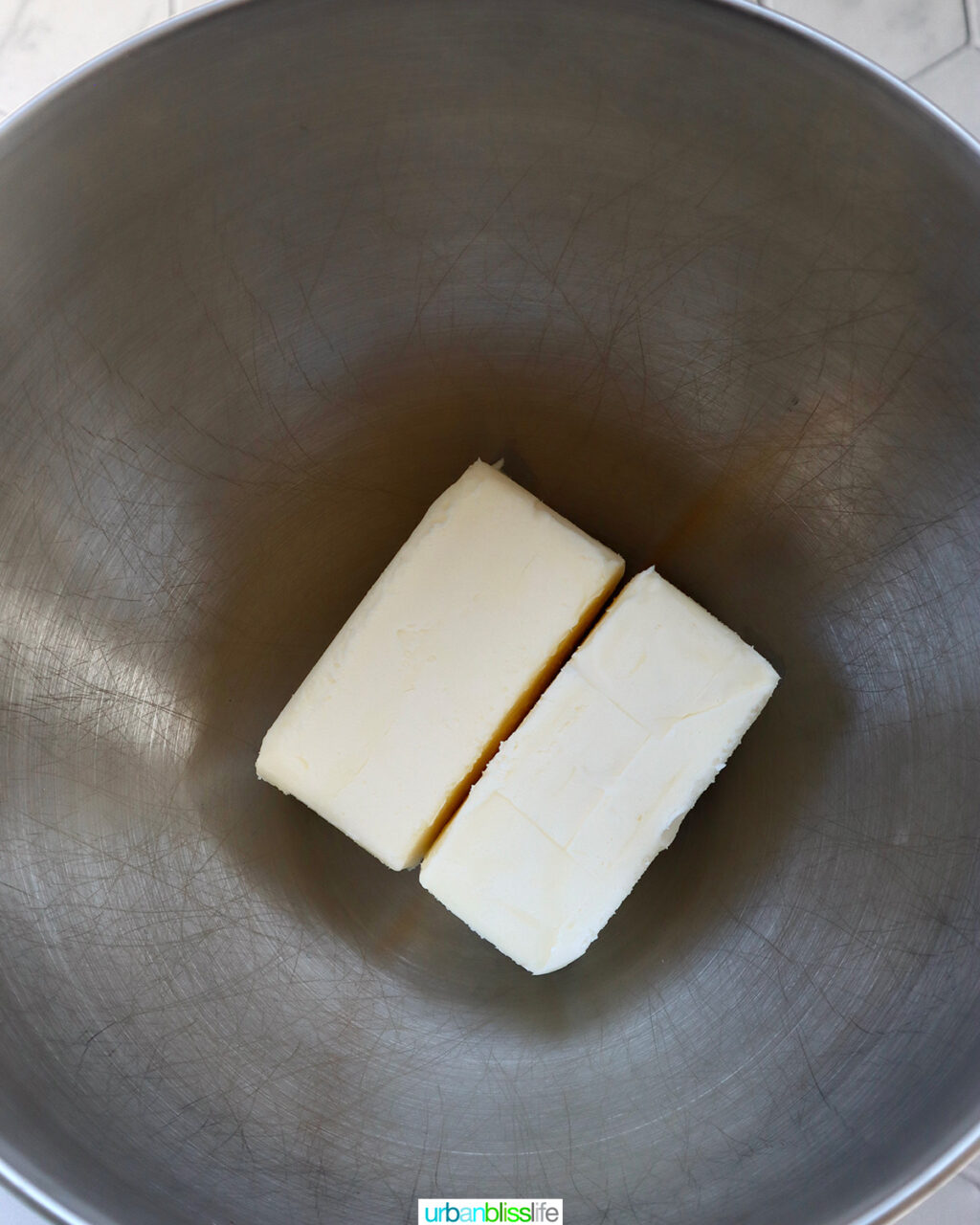 two sticks of butter in a stand mixer bowl.