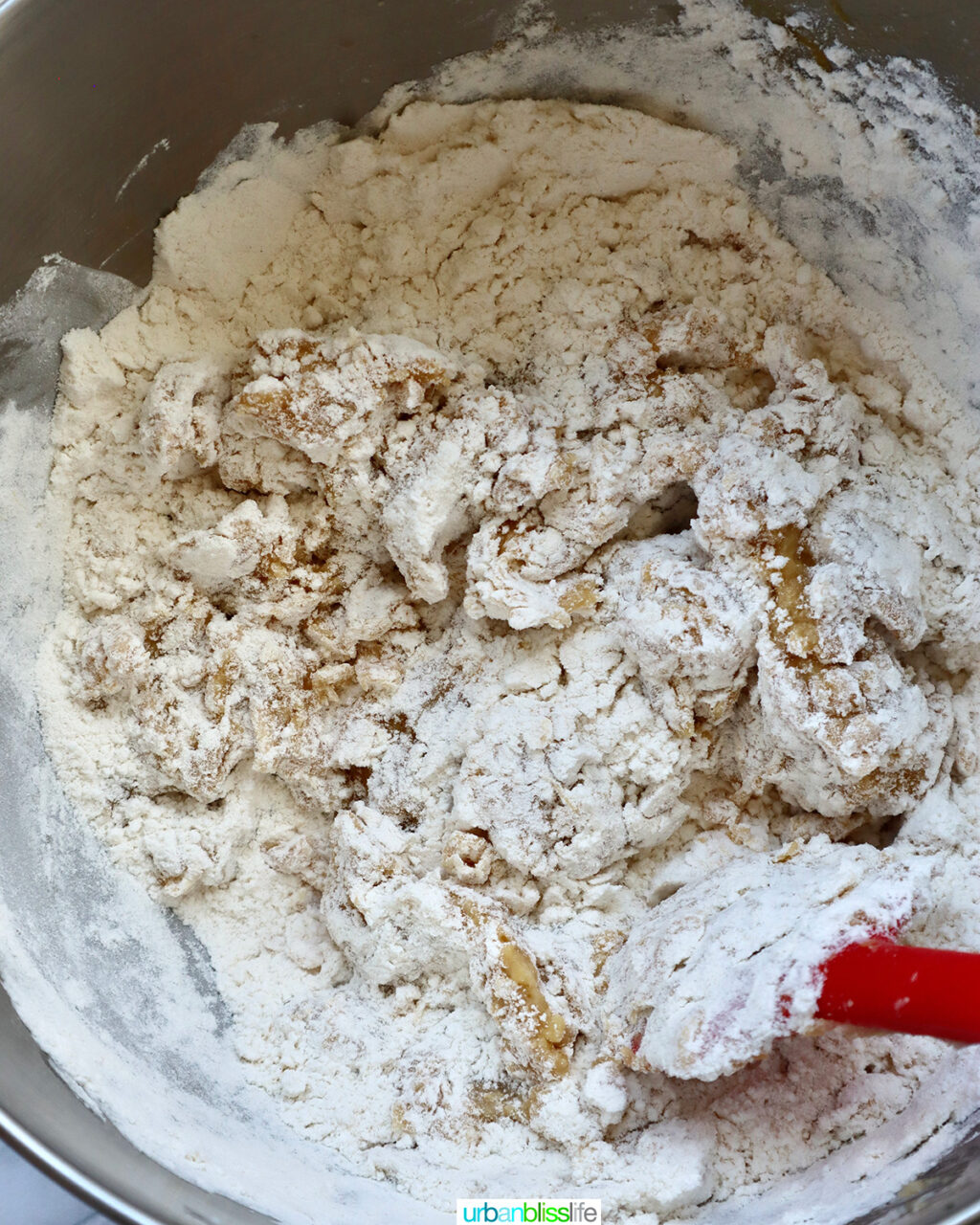 mixing dry ingredients with wet ingredients to make cookie batter.