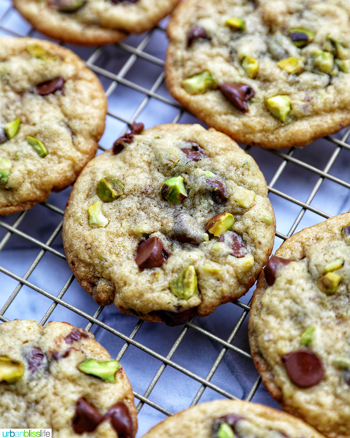 chocolate chip pistachio cookies on a cooling rack.