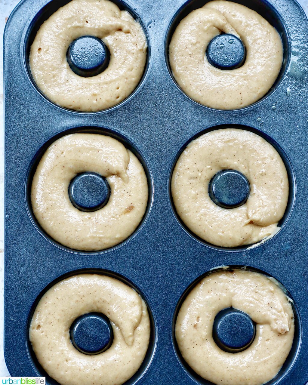 churro donut batter in donut pan.