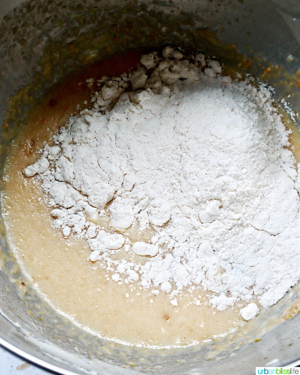 dry ingredients added to wet ingredients in a stand mixer bowl.