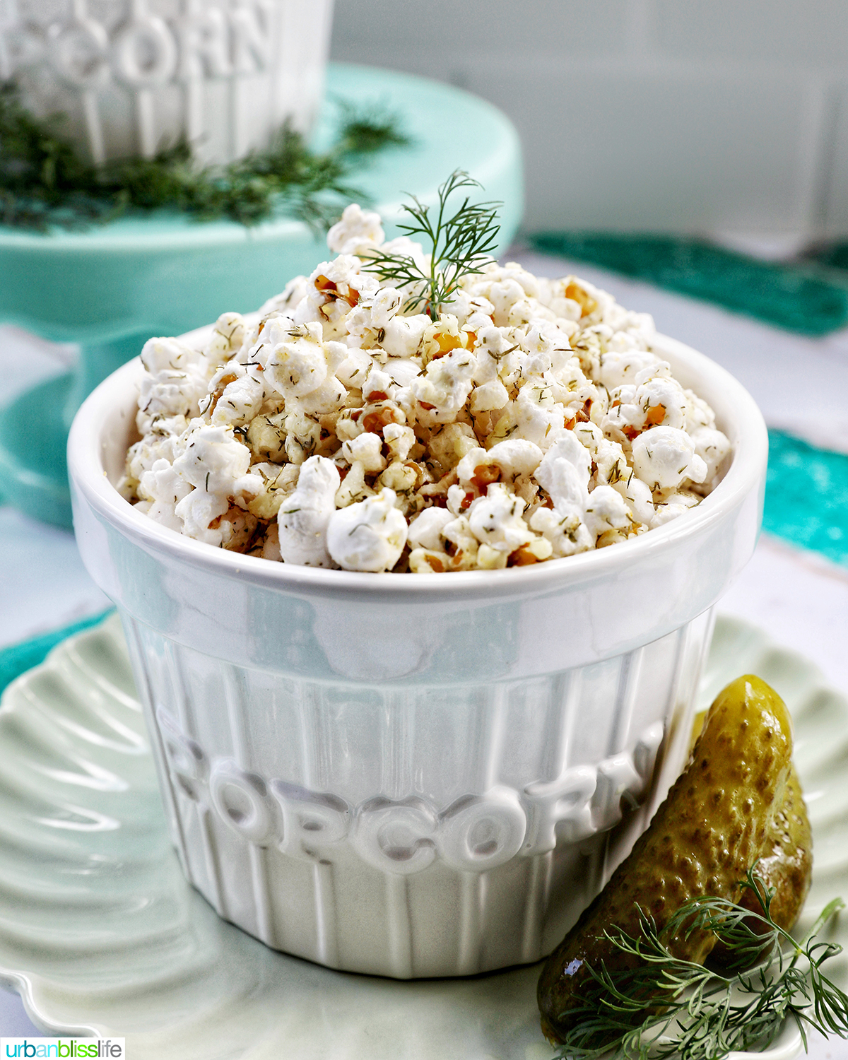dill pickle popcorn in a white bowl.