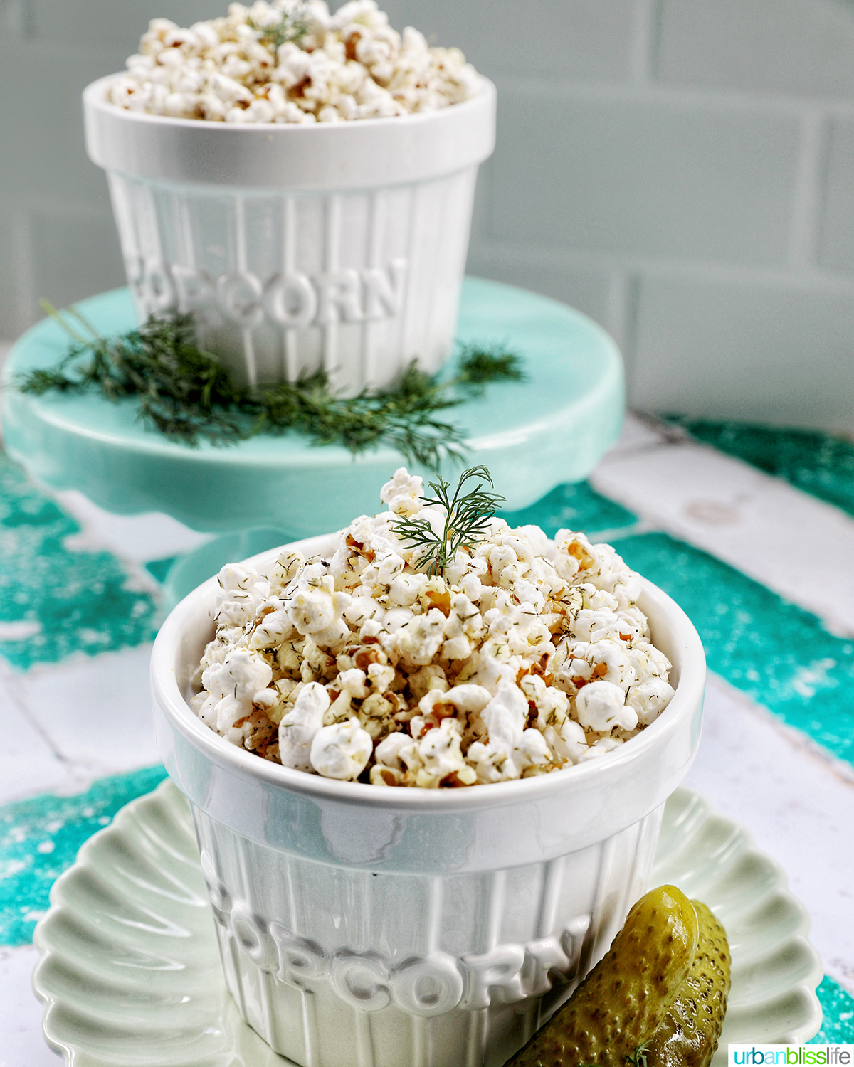 two bowls of dill pickle popcorn.