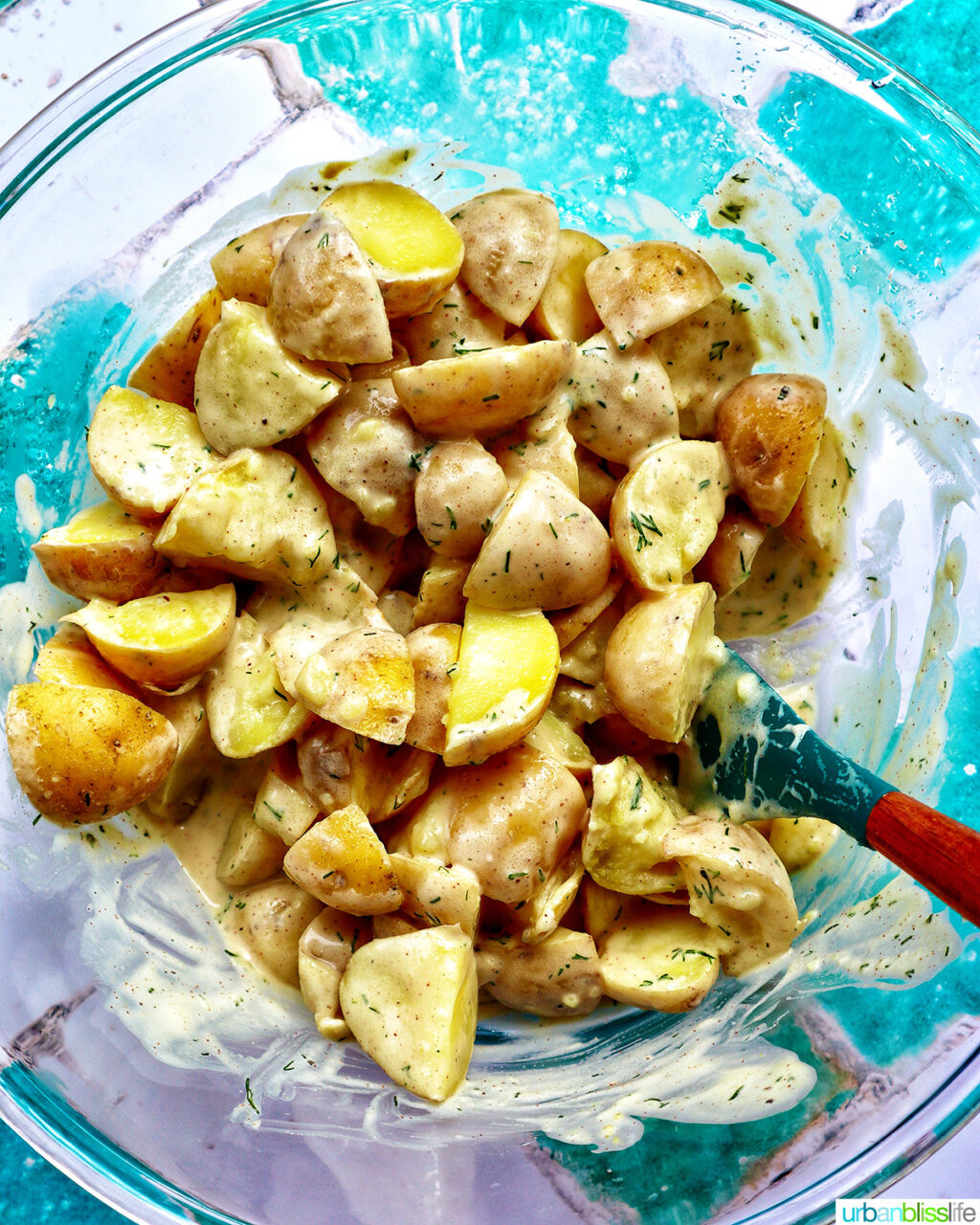 potatoes with dressing in a bowl.