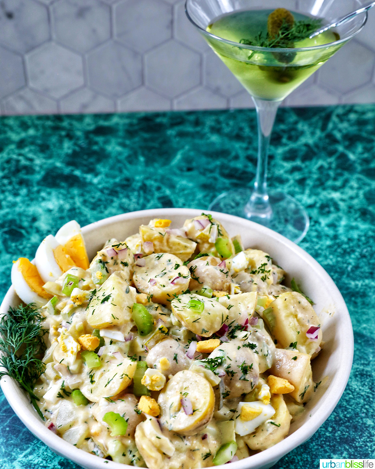 bowl of dill pickle potato salad and a dill pickle martini.