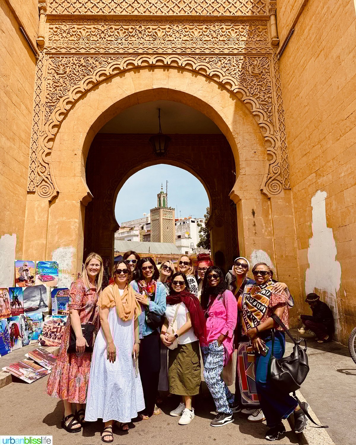 group of women bloggers in front of the historical entrance to the Casablanca medina.