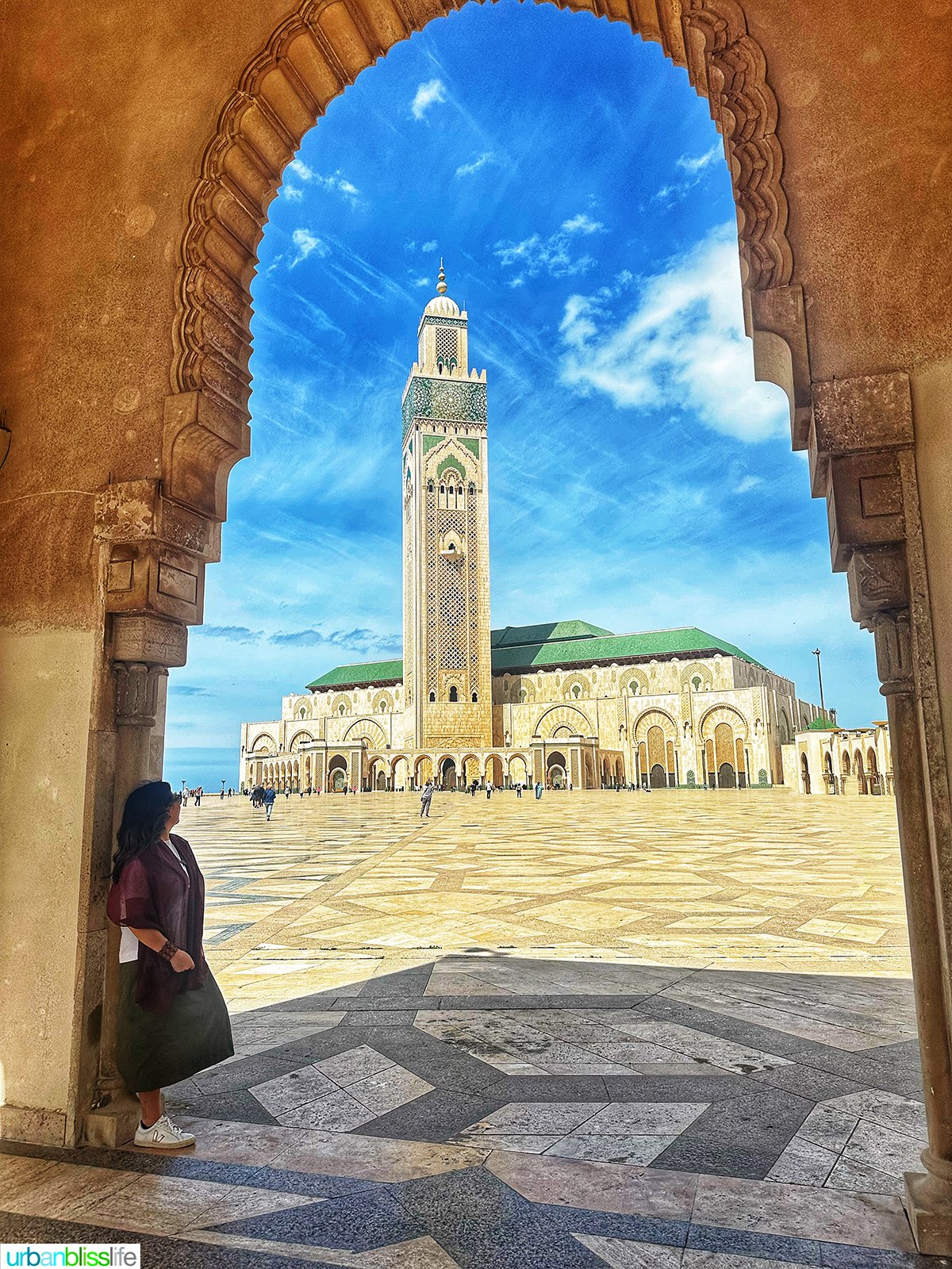 Marlynn Jayme Schotland in doorway with Hassan Mosque II in the background in Casablanca, Morocco.