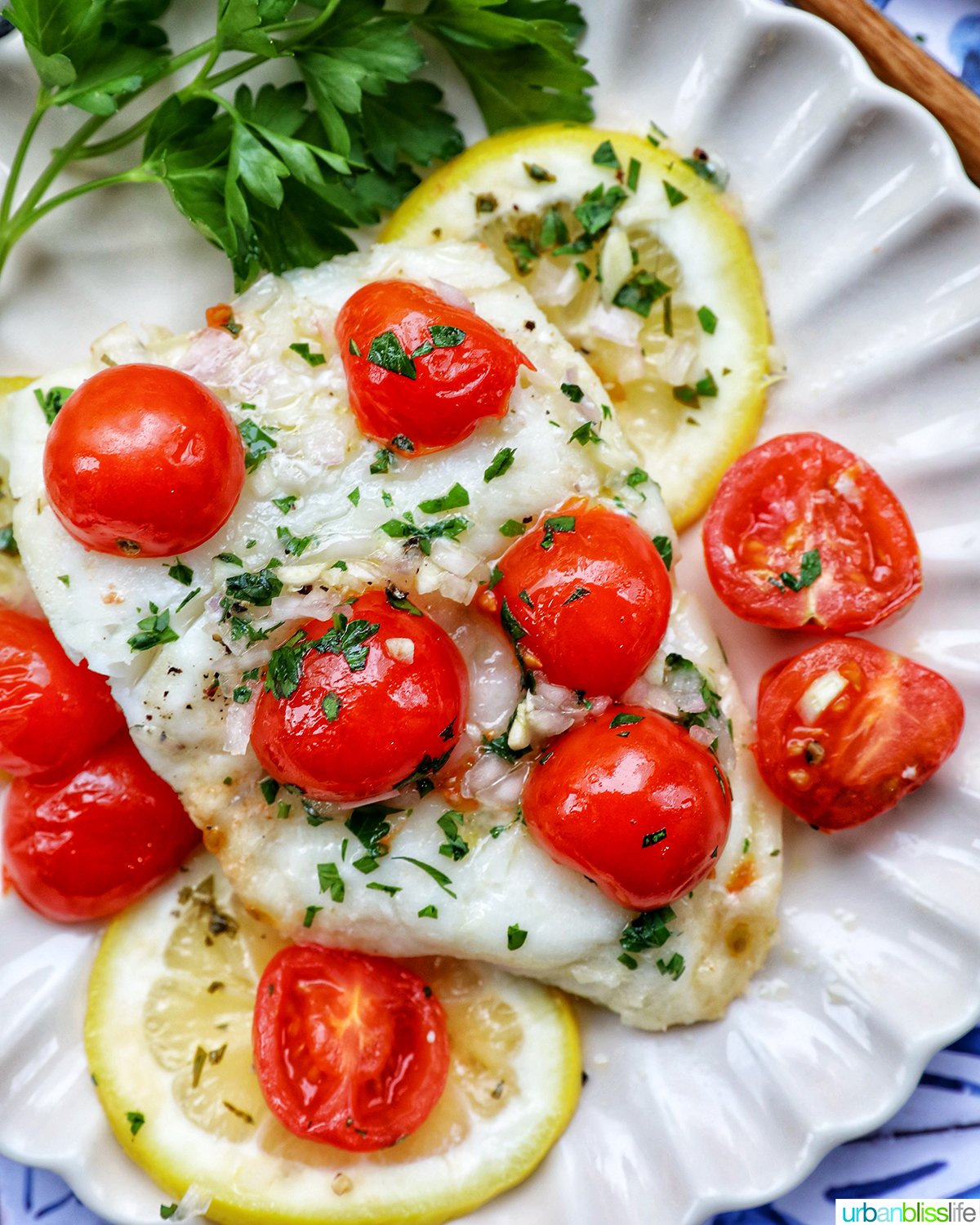 Cod en Papillote on a plate with fresh herbs.