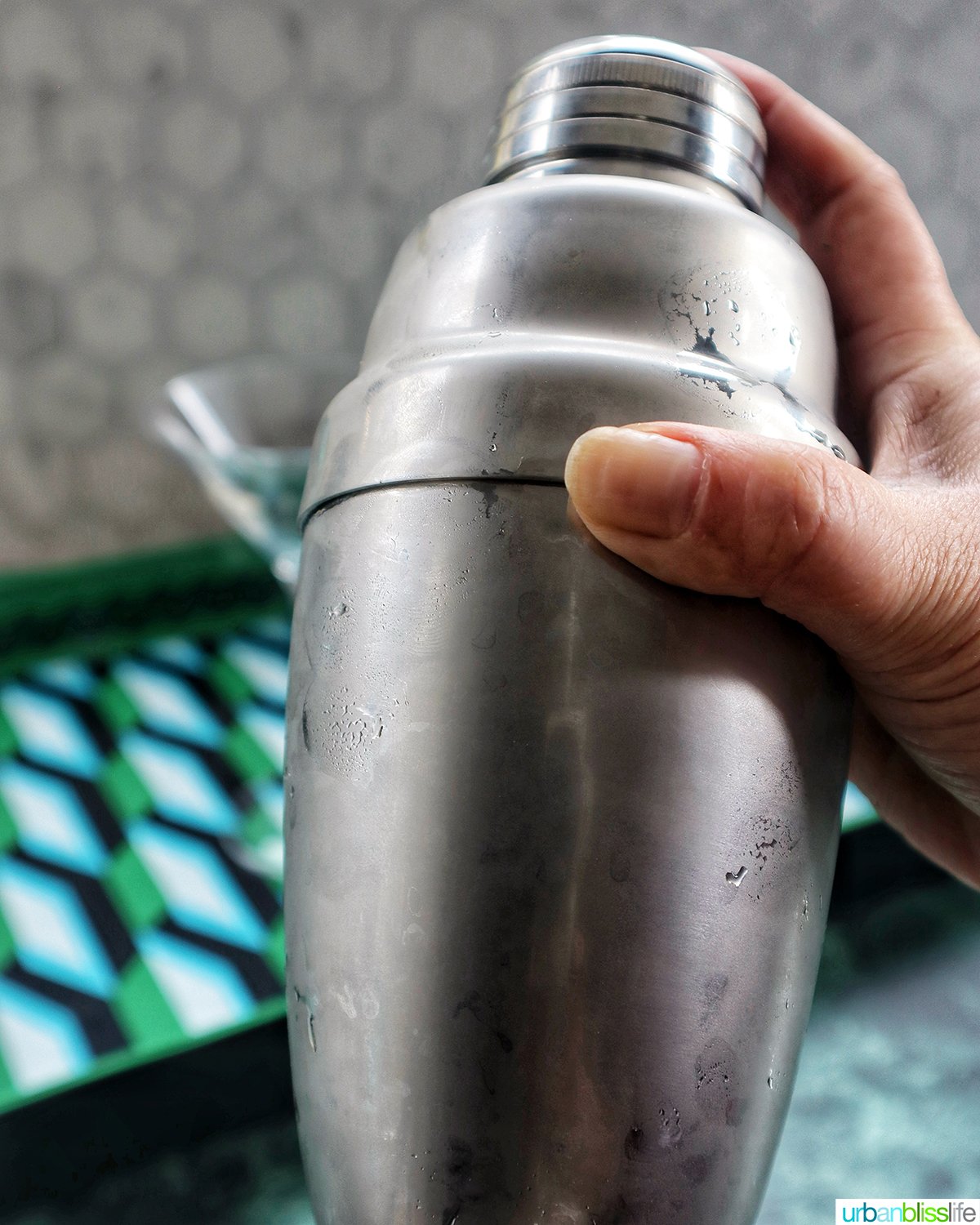 hand shaking a cocktail shaker.