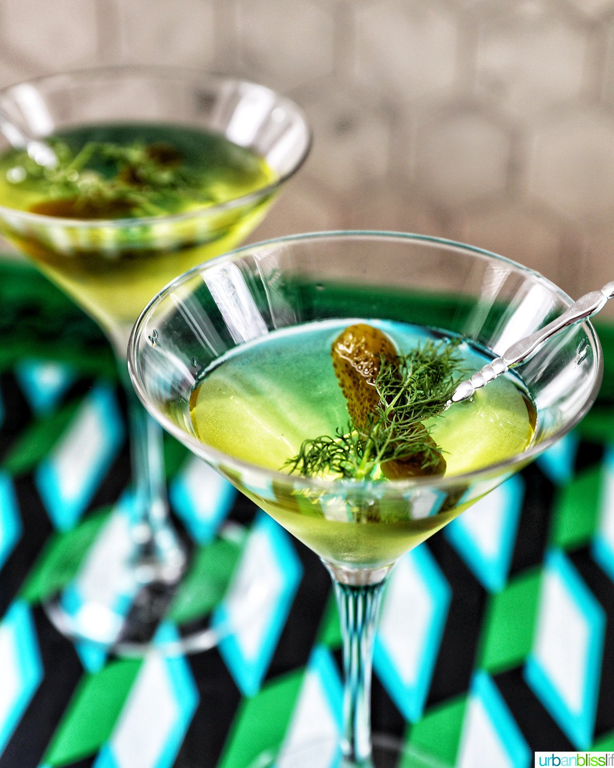 two glasses of dill pickle martinis.